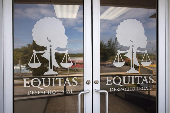 The office's glass doors with the Equitas logo